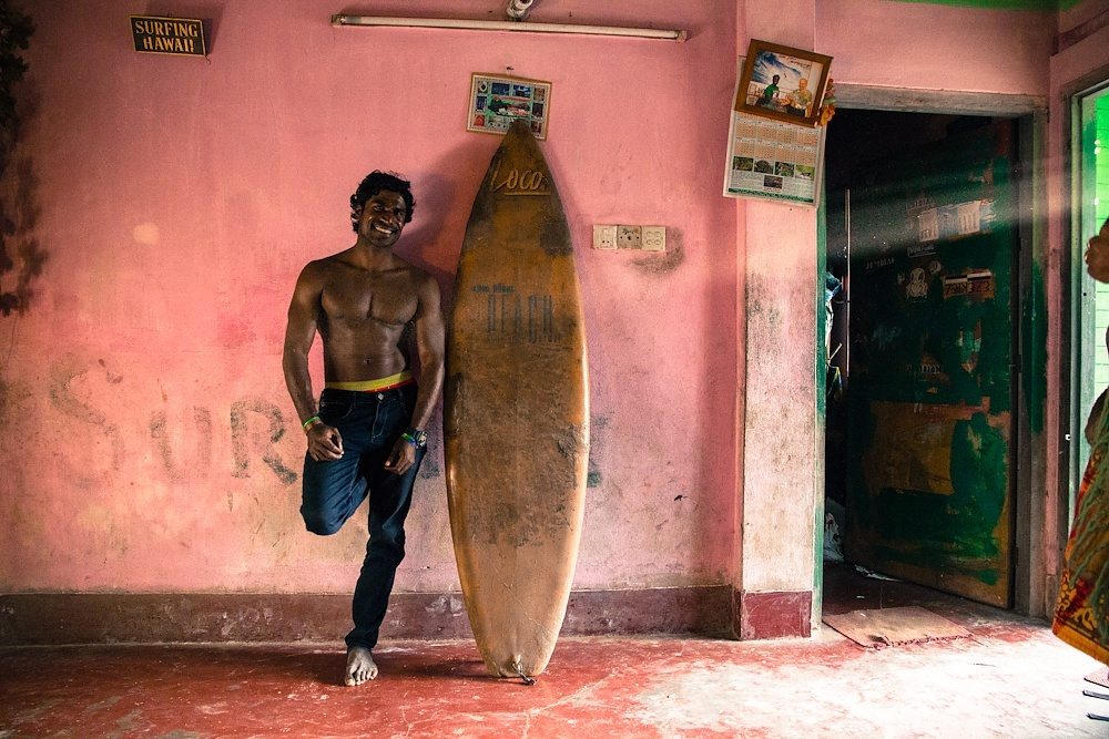 Jafar Alam at home with his first surfboard