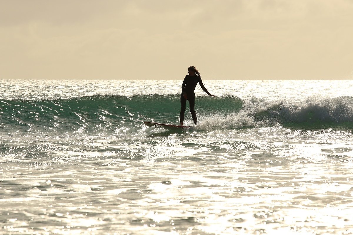 surfergirl riding wave