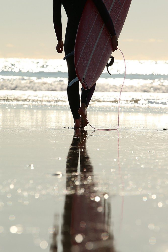 surfergirl at the beach with surfboard