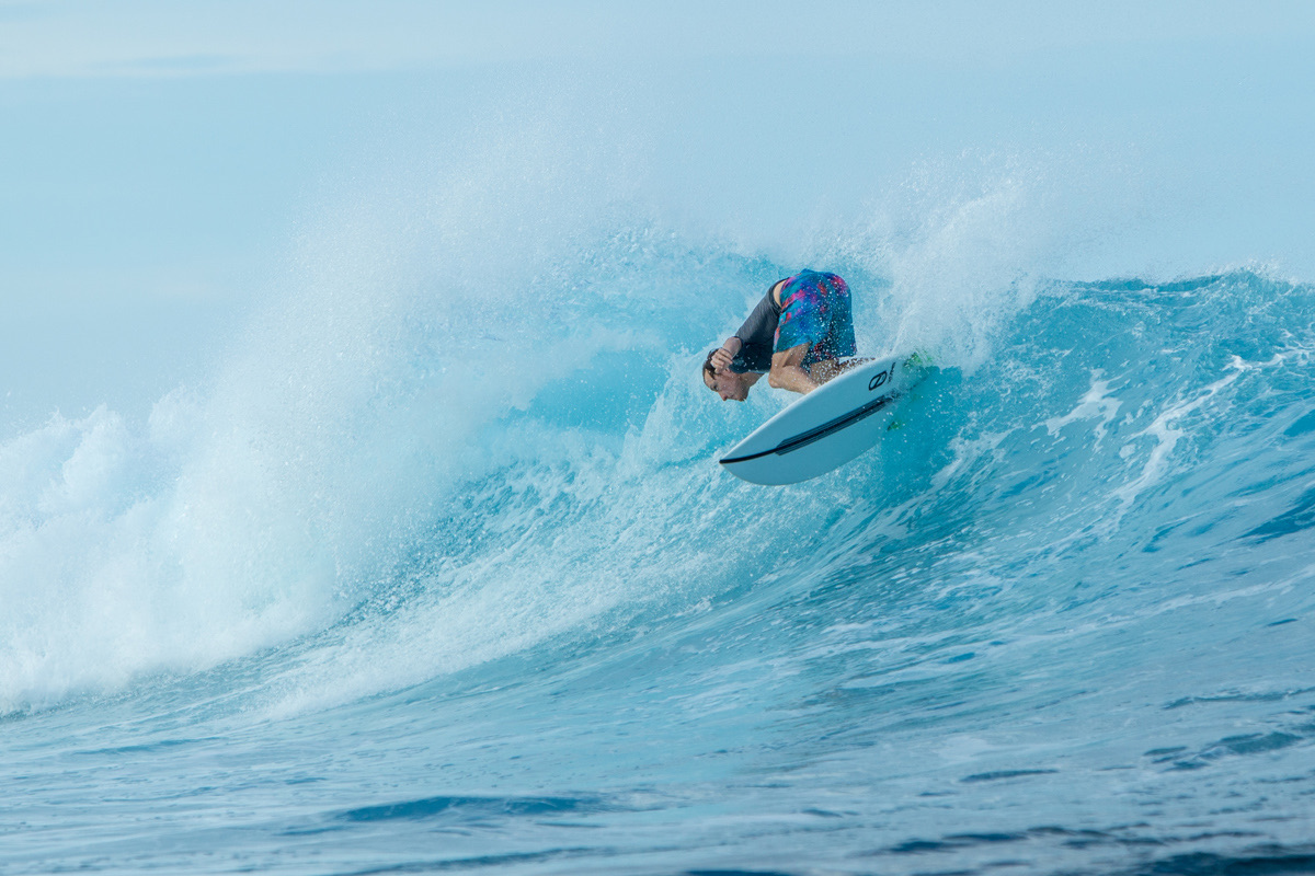 Bradley Hook dropping into a wave on a reef pass in Fiji