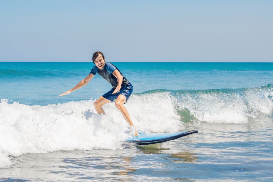 Surfer enjoying surfing lesson