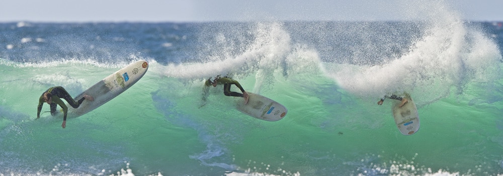 Longboard surfer performing radical turn