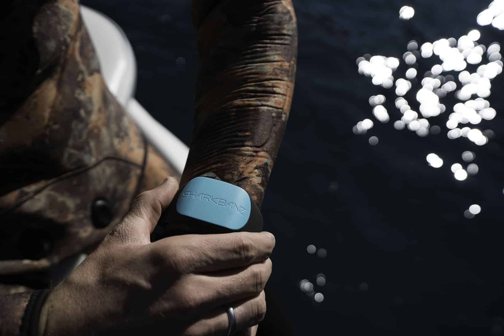 Surfer with Sharkbanz on wrist