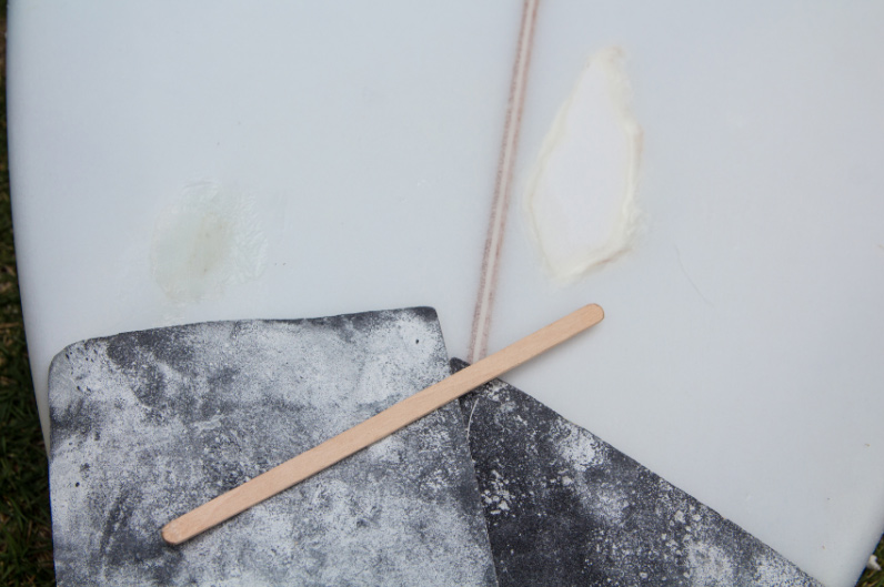 repairing a surfboard ding