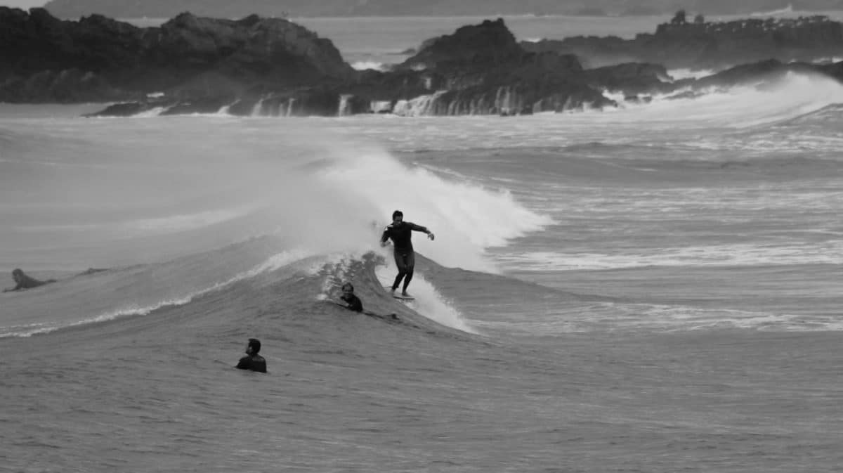Longboard surfer performing traditional nose ride
