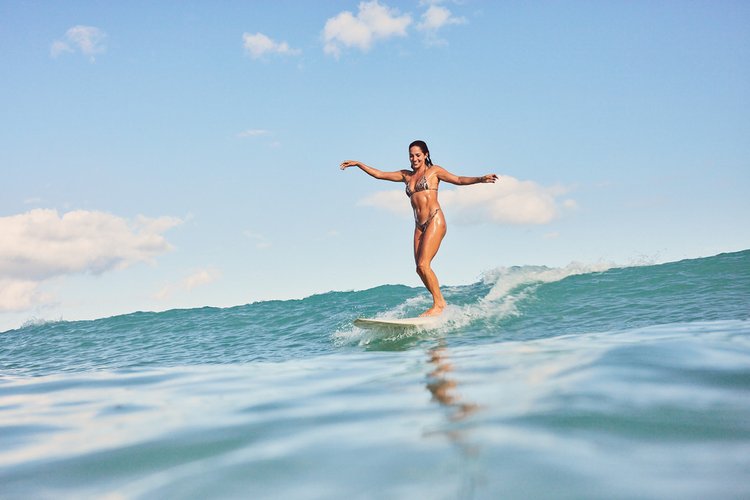 Laura Quintana surfing