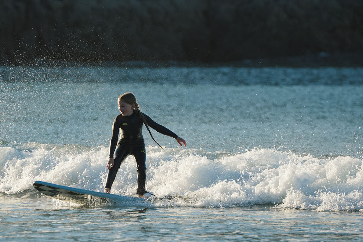 Kid Surfing Xcel Wetsuit