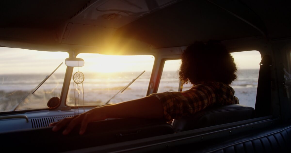 Man relaxing in camper van at beach 4k SBI 350954039