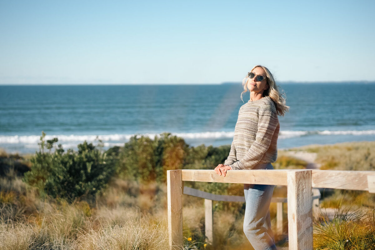 Geniya wearing the Outerknown Horizon Sweater in Sea and Sand Stripe